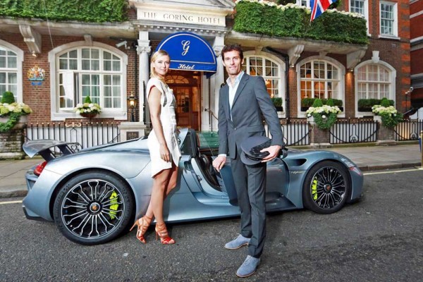 EDITORIAL USE ONLYFrench Open winner, Maria Sharapova, is picked up from The Goring hotel in Central London by Porsche Works Driver and ?world?s fastest chauffeur? Mark Webber, in the plug-in hybrid Porsche 918 Spyder and driven to the Women's Tennis Association (WTA) Pre-Wimbledon Party at the Kensington Roof Gardens. PRESS ASSOCIATION Photo. Picture date: Thursday June 19, 2014. Hitting 0-60 mph in 2.5 seconds and with a top speed of 214 mph, the 918 Spyder is the most powerful road car Porsche has built to date, yet is exempt from the Congestion Charge as the plug-in hybrid super sports car emits less CO2 than most small cars and many other hybrid vehicles. Photo credit  should read: Matt Alexander/PA Wire