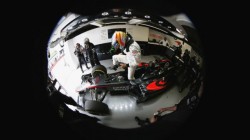 Fernando Alonso climbs from his car in the garage.