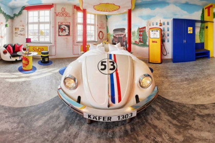 v8-hotel-in-this-photo-the-gas-stations-suite-is-shown-with-herbie-bed-gas-pumps-and-neon-light
