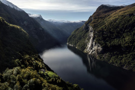 NORWAY. 2016. Geiranger fjord.
Looking towards the "seven sisters" waterfall, with SkageflÎÂ¥, and abandoned farm, in the foreground.