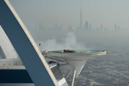 David Coulthard of Scotland performs in the RB7 Infinity Red Bull Racing car on the helipad of the Burj Al Arab hotel in Dubai, United Arab Emirates on October 30, 2013.